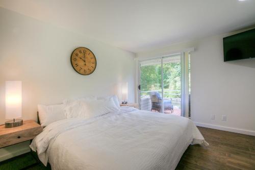 een slaapkamer met een bed met een klok aan de muur bij Moon River Suites #3 in North Bend