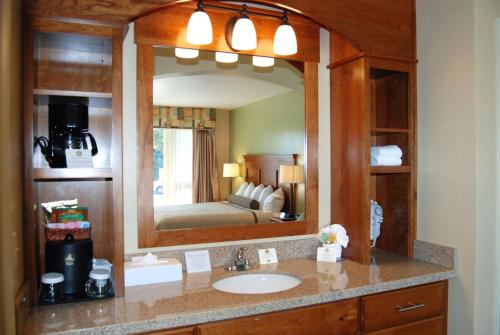 a bathroom with a sink and a large mirror at Best Western Driftwood Inn in Idaho Falls