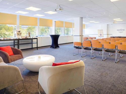 a conference room with chairs and a table and a white table at Novotel Warszawa Airport in Warsaw
