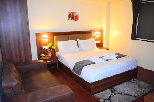 a hotel room with a bed and a couch at Amba Regency in Gangtok