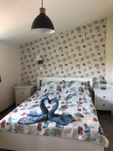 a bedroom with a bed with two snakes on it at Villa Casa Mia in Balatonlelle