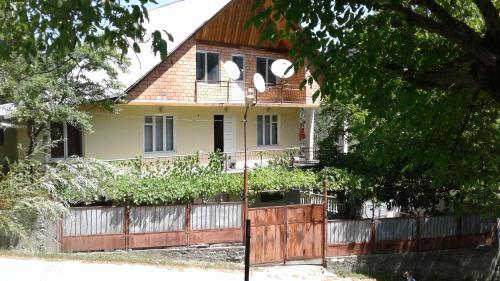 a house with a wooden fence in front of it at Toma's vila in Borjomi