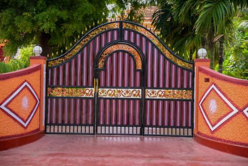 a red gate with an ornate design on it at Tulip Guest Inn in Point Pedro