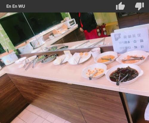 a buffet with plates of food on a table at Chateau Motel & Spa (Daliao) in Daliao