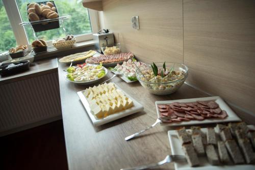 un tavolo con molti tipi diversi di cibo su di esso di 4family *RESORT*SPA* a Szklarska Poręba