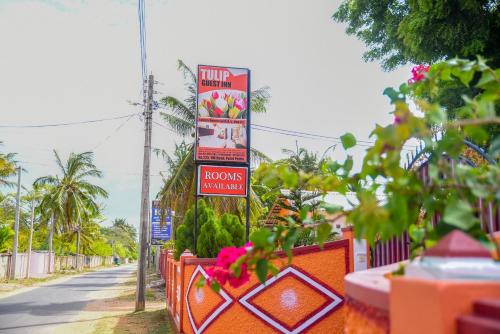 a street with a sign for a honos restaurant at Tulip Guest Inn in Point Pedro
