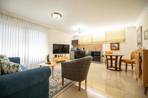 a living room with a couch and a table at sul mare סוויטות in Ashqelon