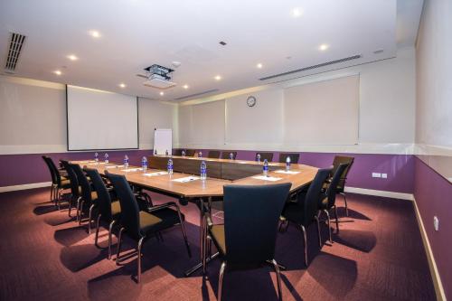 a large conference room with a long table and chairs at Premier Inn Dubai Investments Park in Dubai