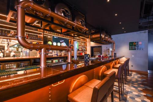a bar with a row of seats at a restaurant at Premier Inn Dubai Al Jaddaf in Dubai