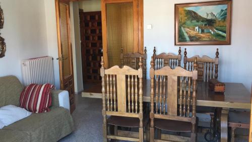 a living room with a wooden crib and a table at Vivienda uso turistico Atalaya in El Burgo de Osma