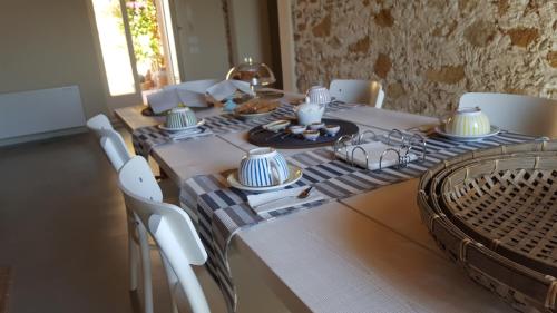 a dining room table with a blue and white table cloth at B&B Attico Taranto in Caltagirone