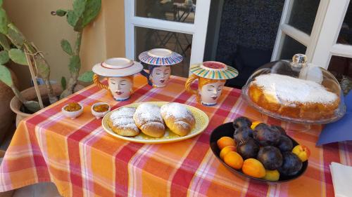 a table with a plate of bread and other food at B&B Attico Taranto in Caltagirone