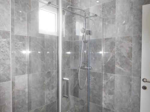 a bathroom with a shower with a glass door at Villa Aronija in Kotor
