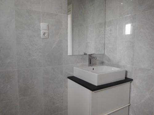 a bathroom with a white sink and a mirror at Villa Aronija in Kotor
