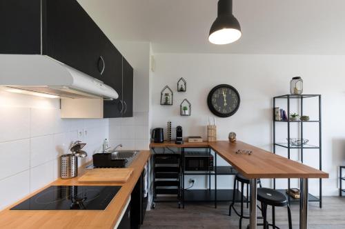 a kitchen with a wooden counter top and a table at South West in Anglet