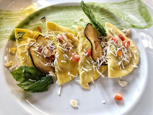 a white plate of food with nachos on it at Posta Donini 1579 - UNA Esperienze in San Martino in Campo