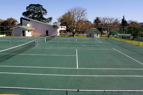 a tennis court with two tennis nets on it at Eight Bells Mountain Inn in Ruiterbos