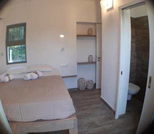 a bedroom with a bed and a bathroom with a toilet at A Sea of Stars in Pefki Rhodes