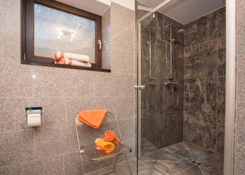 a bathroom with a shower with a glass door at Ferienwohnung Steinacker am Gerkenstein in Winterberg