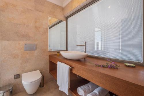 a bathroom with a sink and a large window at On Oda Oludeniz in Oludeniz