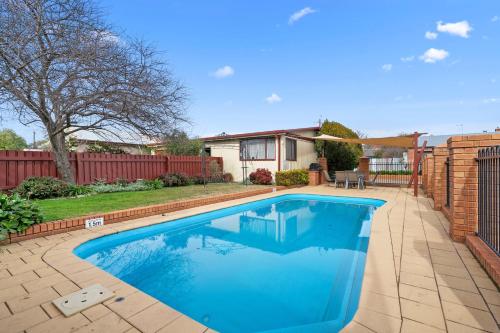a swimming pool in the backyard of a home at Comfort Inn Heritage Wagga in Wagga Wagga