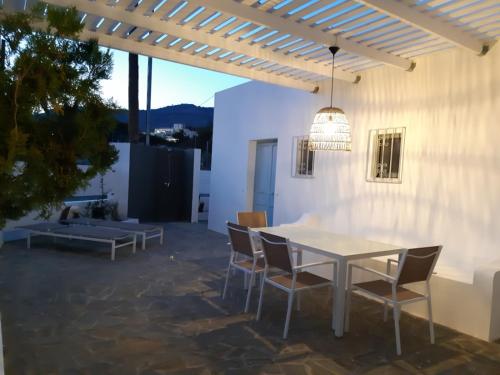 a patio with a white table and chairs at A Sea of Stars in Pefki Rhodes