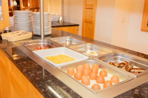 a kitchen counter with a tray of eggs and other food at ARBOR Hotel & Apartments in Saalbach Hinterglemm