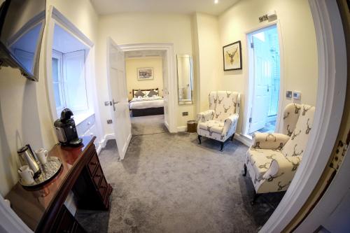 a hallway with chairs and a bed in a room at Wortley Hall Sheffield in Sheffield