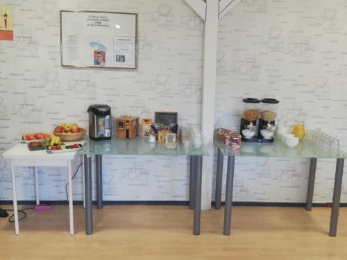 a counter with a table with fruit on it at Pension Check In in Güstrow