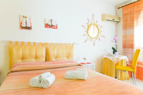 a bedroom with two towels on a bed at B&b Margherita in Calasetta