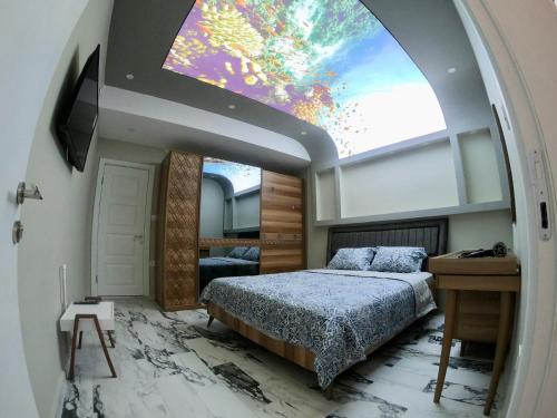 a bedroom with a bed and a large window at PASHA APART~BOUTİQUE HOTEL/YALOVA in Yalova