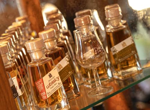 a group of bottles of oil sitting on a shelf at Hotel Waldblick in Schenkenzell