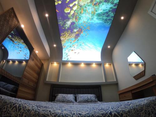a bedroom with a large painting on the wall at PASHA APART~BOUTİQUE HOTEL/YALOVA in Yalova