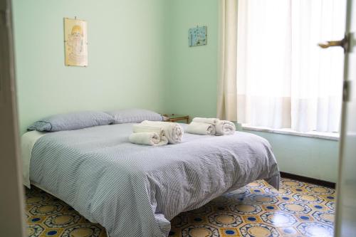 a bedroom with a bed with towels on it at Le Vigne - Villa overlooking Etna in Adrano