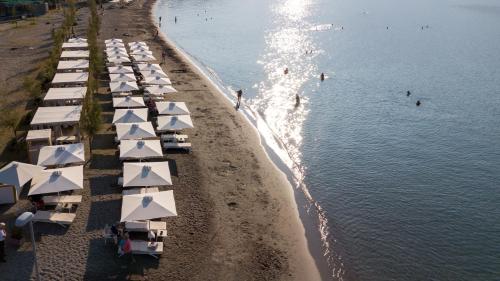 an aerial view of a beach with umbrellas at Pharae Palace in Kalamata