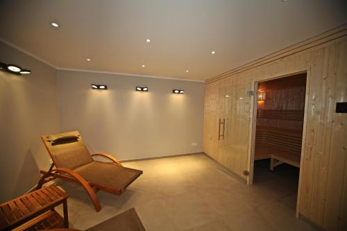 a living room with a chair and a closet at Villa Düne -Penthousewohnung WE 18 in Baabe