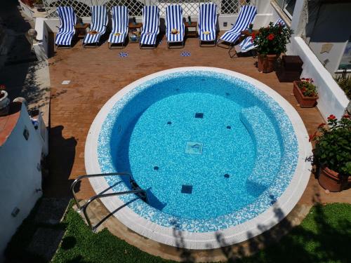an overhead view of a swimming pool in a yard with chairs at Villa Patrizi in Capri