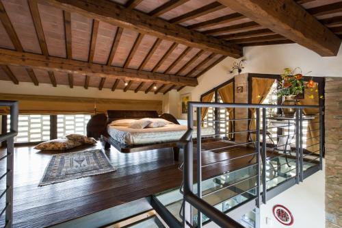a bedroom with a bed and a wooden ceiling at Fattoria Pogni in Marcialla