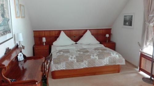 a bedroom with a bed with two pillows on it at Ferienwohnung Kück-Rathausstrasse in Hahnenklee-Bockswiese