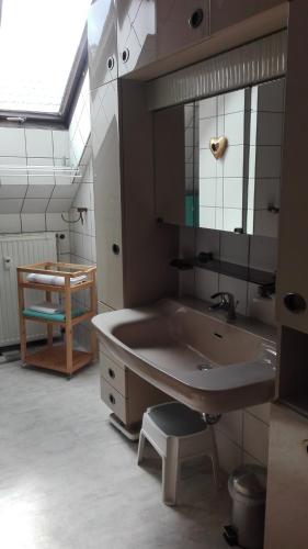 a bathroom with a large tub and a sink at Ferienwohnung Kück-Rathausstrasse in Hahnenklee-Bockswiese