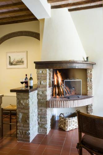 a stone fireplace in a living room at Fattoria Pogni in Marcialla