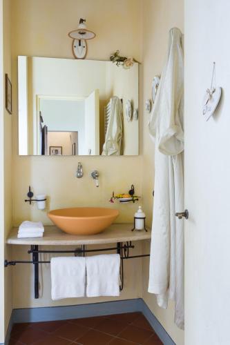 a bathroom with a bowl sink and a mirror at Fattoria Pogni in Marcialla