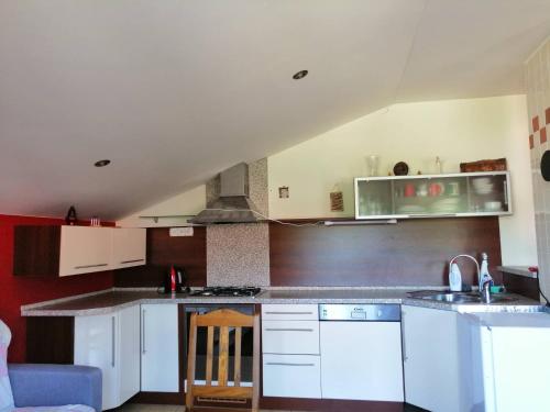 a kitchen with white cabinets and a stove top oven at Villa Victoria Penzion in Liptovský Ján