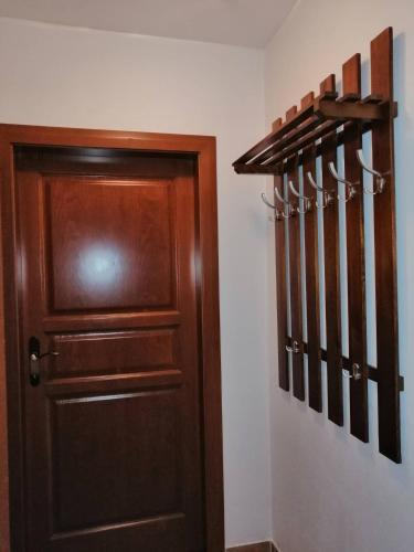 a wooden door in a hallway next to a wall at Villa Victoria Penzion in Liptovský Ján