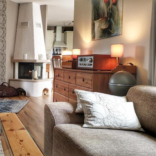 a living room with a couch and a stove at Haus Tina in Mölln
