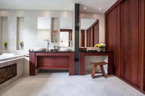 a bathroom with a sink and a mirror at Baan Pinya Balinese Style Pool Villa in Krabi town