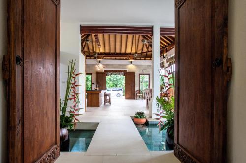 an open hallway with potted plants in a house at Baan Pinya Balinese Style Pool Villa in Krabi town