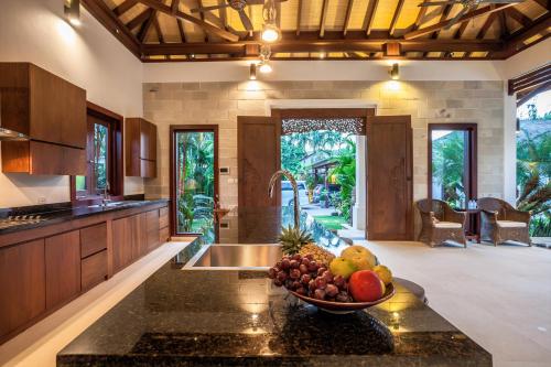a kitchen with a bowl of fruit on a counter at Baan Pinya Balinese Style Pool Villa in Krabi town