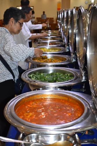 a row of plates of food in a buffet at HOTEL ANAND INTERNATIONAL in Bodh Gaya