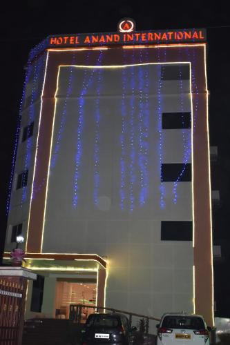 a hotel with blue lights on the side of a building at HOTEL ANAND INTERNATIONAL in Bodh Gaya